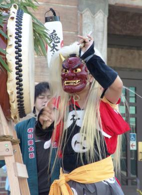 Person in a demon mask practices the tradition of Ondeko (demon drumming)